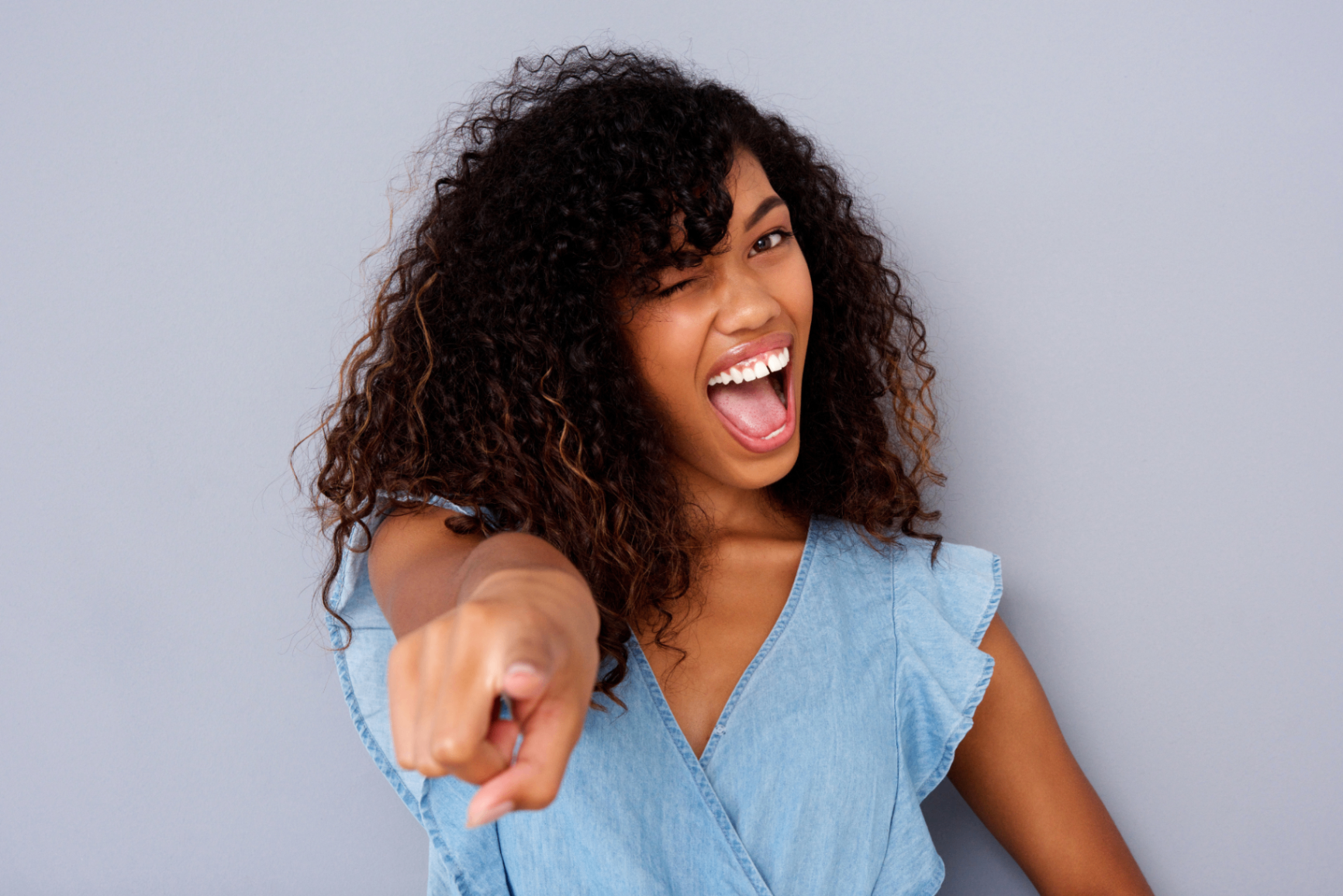 A joyful woman representing warmth, friendliness and confidence.