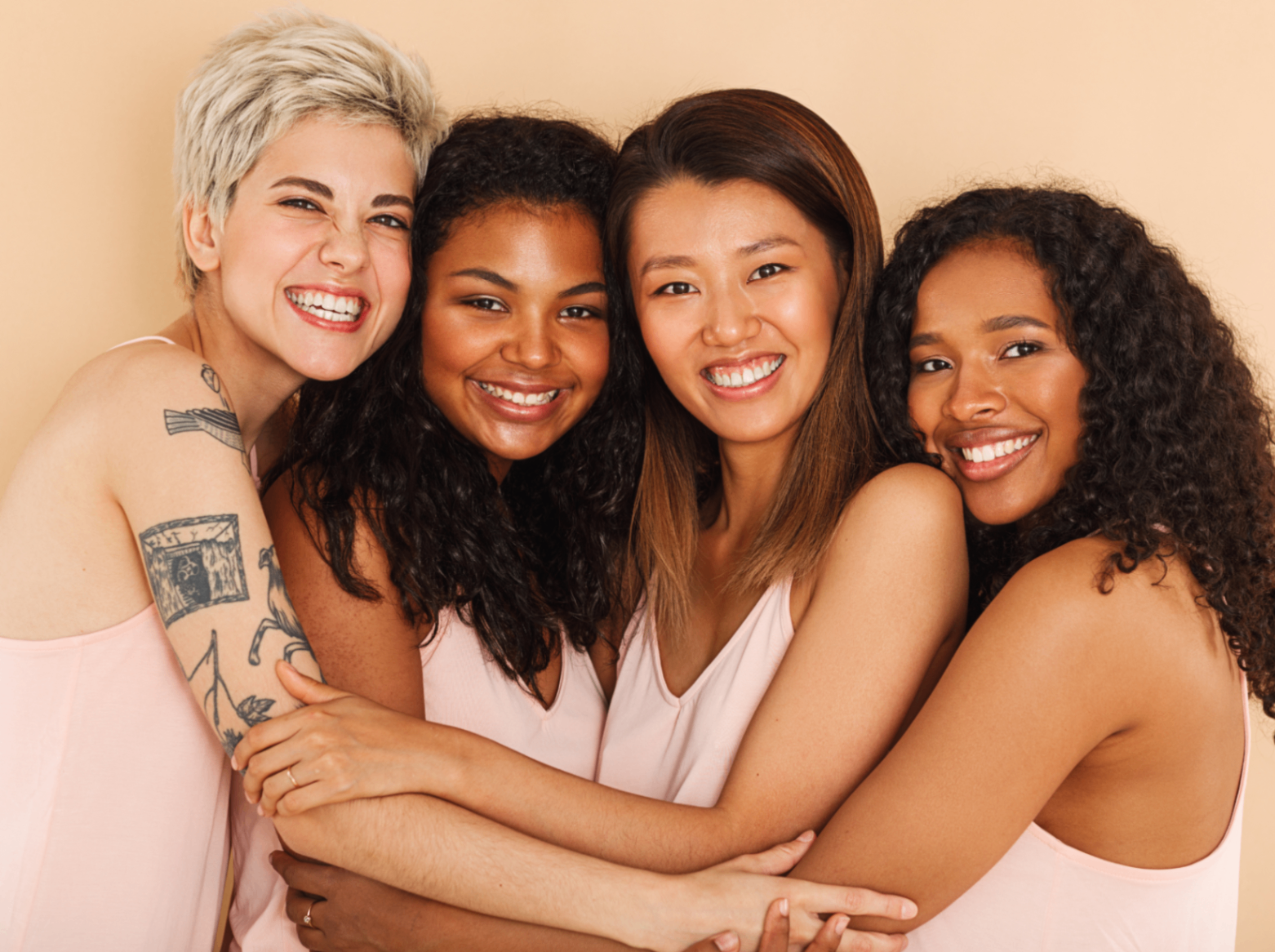 Women smiling together to express confidence and empowerment.